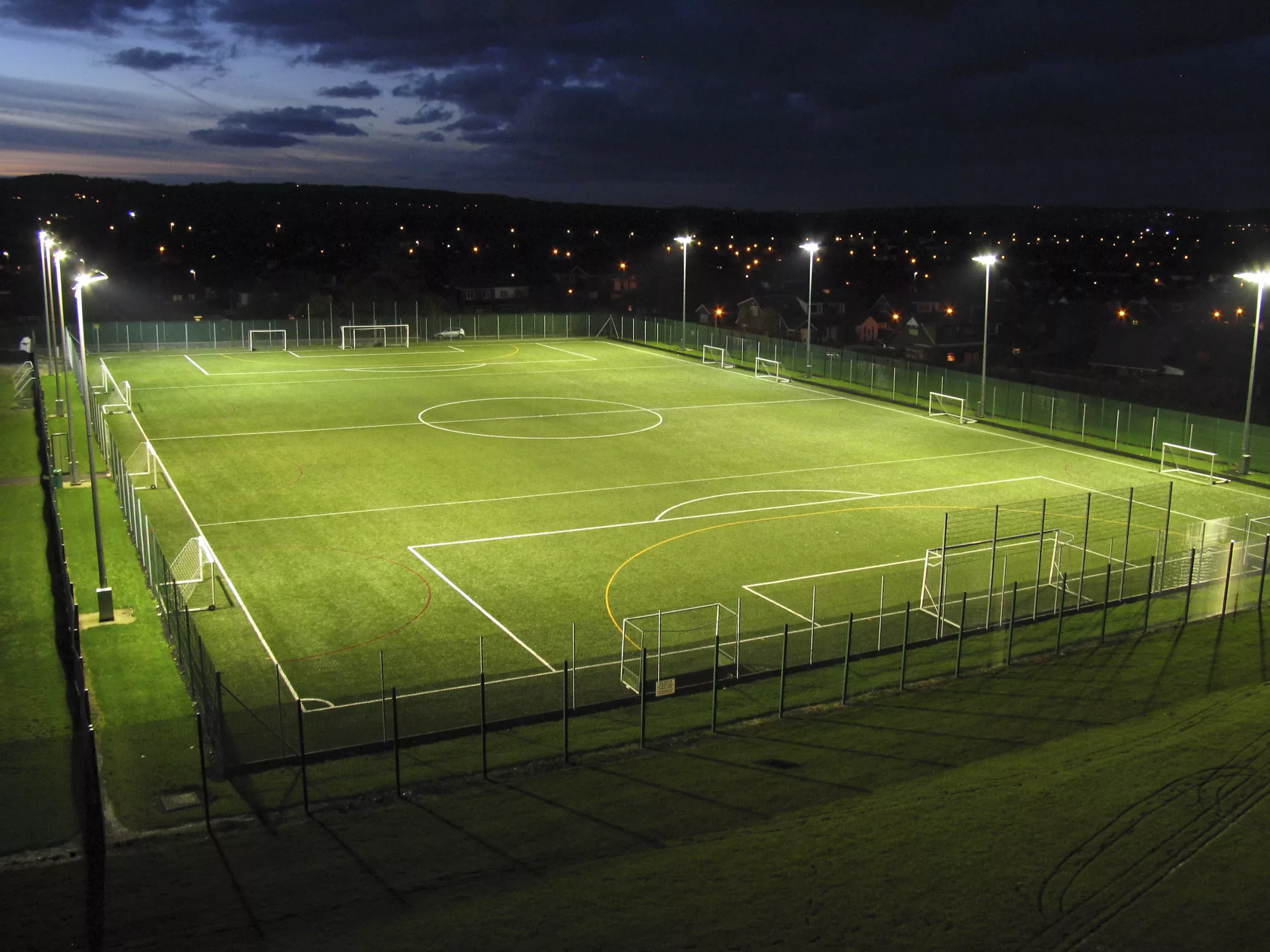 Stadium Lighting With Green Field at Night